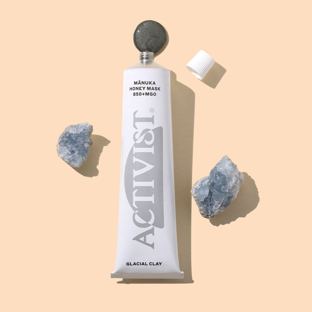 Activist | Mānuka Honey Glacial Clay Mask | Styled Image with Swatch_Sep26 - tube with clay swatch and crystals on a peach background