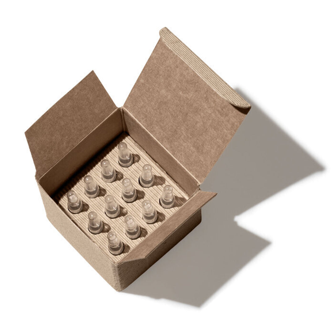 Ayuna | Longeva | Open Box Packaging Image - open cardboard box containing multiple ampoules arranged in a tray on a white background