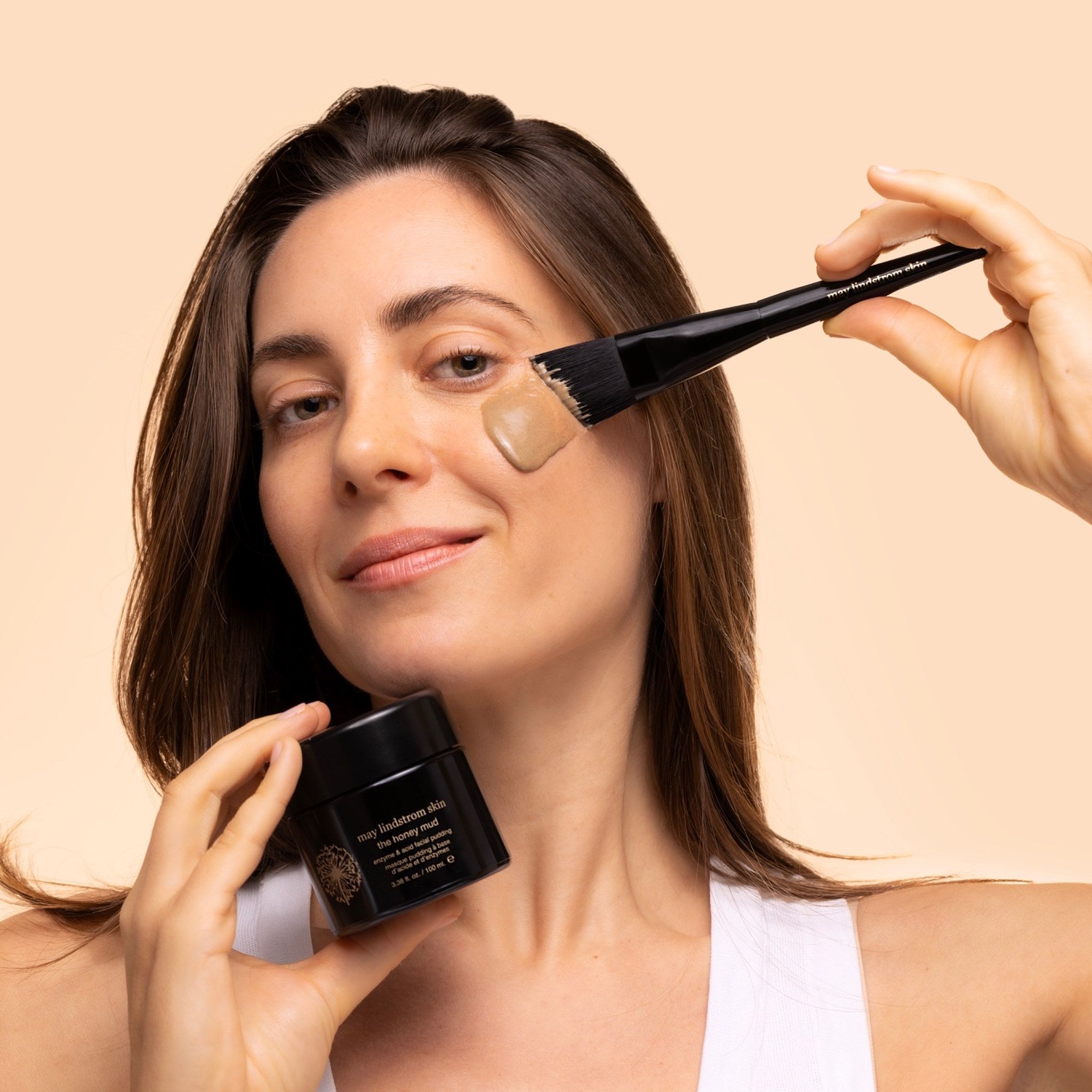 May Lindstrom The Honey Mud - Woman applying to face with Treatment Brush