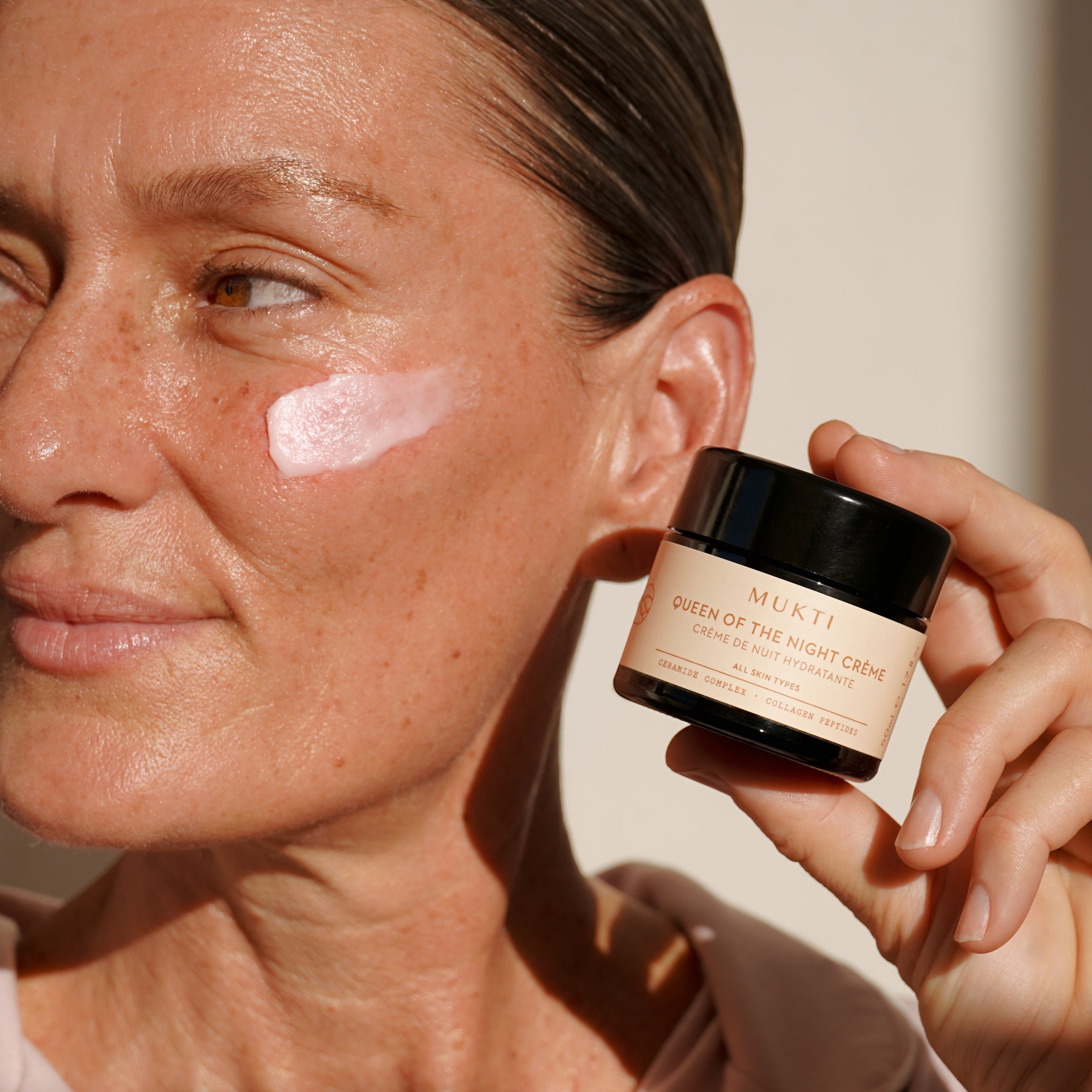Mukti | Queen of the Night Creme | model with swatch on cheek