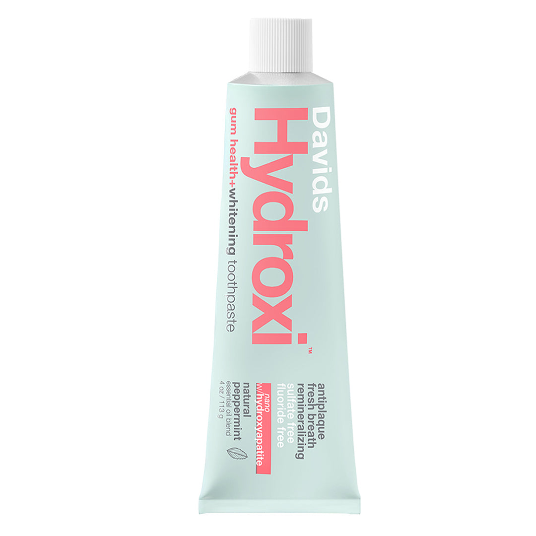 Davids | Hydroxi™ Gum Health + Whitening Nano Toothpaste - Peppermint | Product Image - green toothpaste tube with pink lettering and a white cap on a white background
