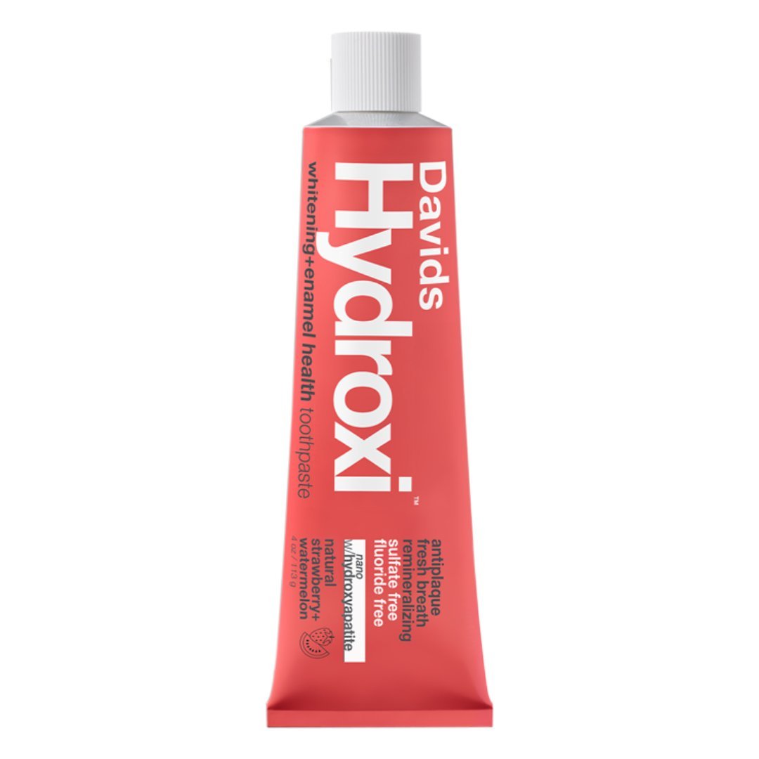 Davids | Hydroxi™ Kids + Adults Toothpaste - Strawberry + Watermelon | Product Image - red product tube laying on a white background