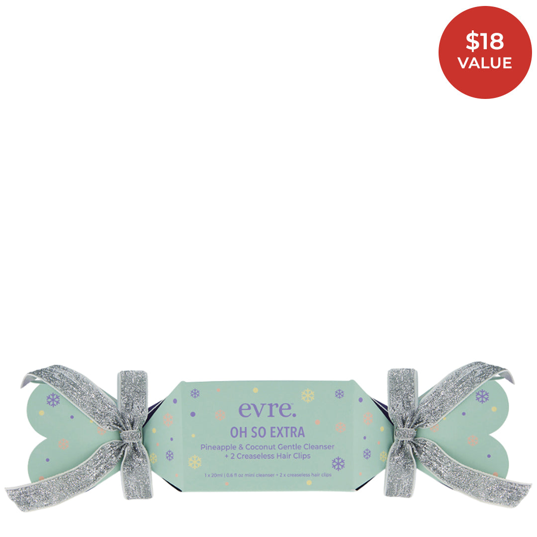 Evre | Oh So Extra Gentle Cleanser | Product Image with Red Sticker - festive cracker packaging with silver ribbons on a white background