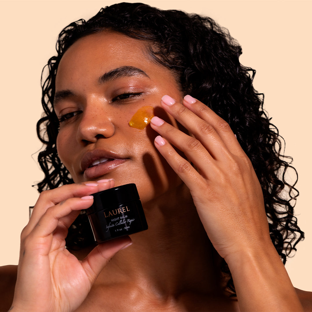 Laurel Skin | Night Balm | Model Image_Jul26 - model holding jar while applying the balm to the cheek