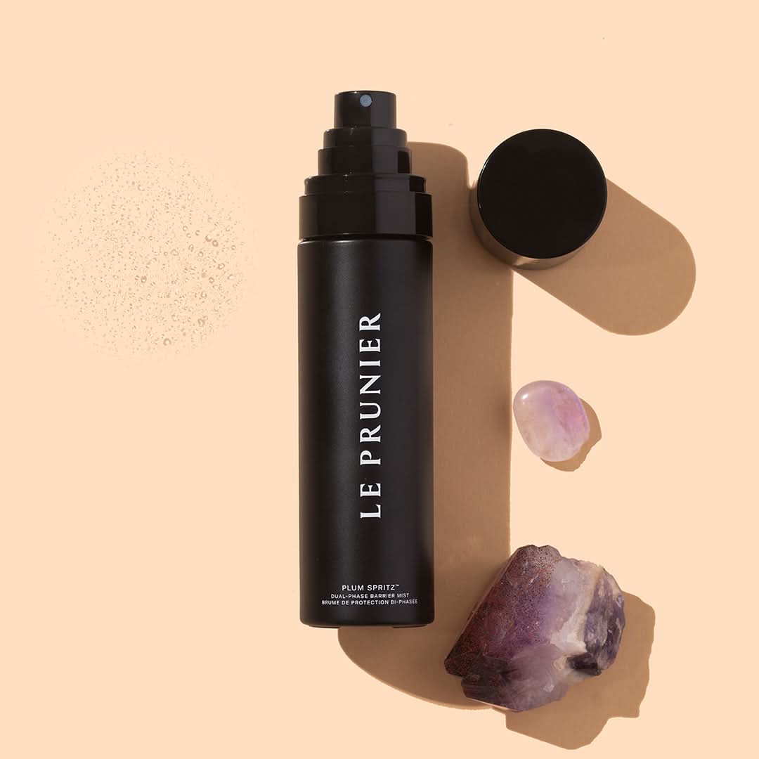 Le Prunier | Plum Spritz | Styled Image - mist bottle with cap, crystals, and water droplets on a beige background