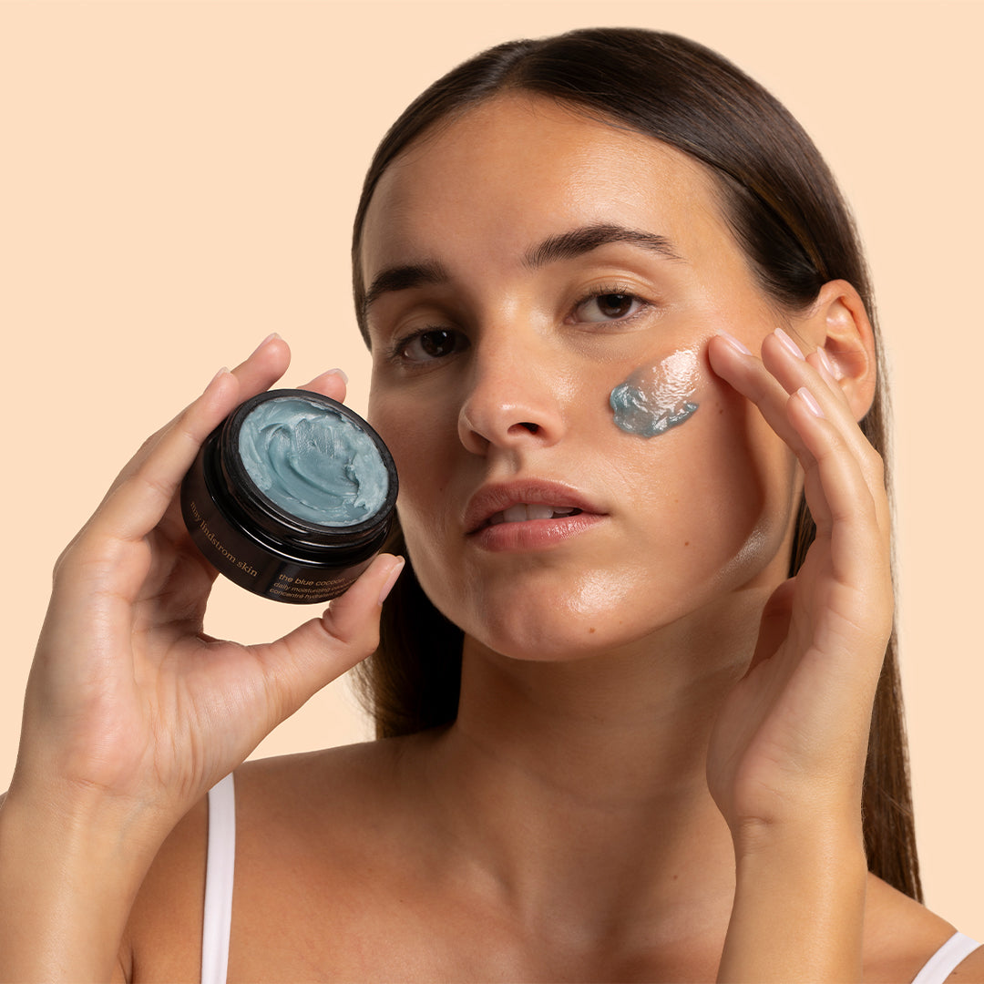 May Lindstrom Skin | The Blue Cocoon | Model Image_Oct26 - model applying The Blue Cocoon to her cheek