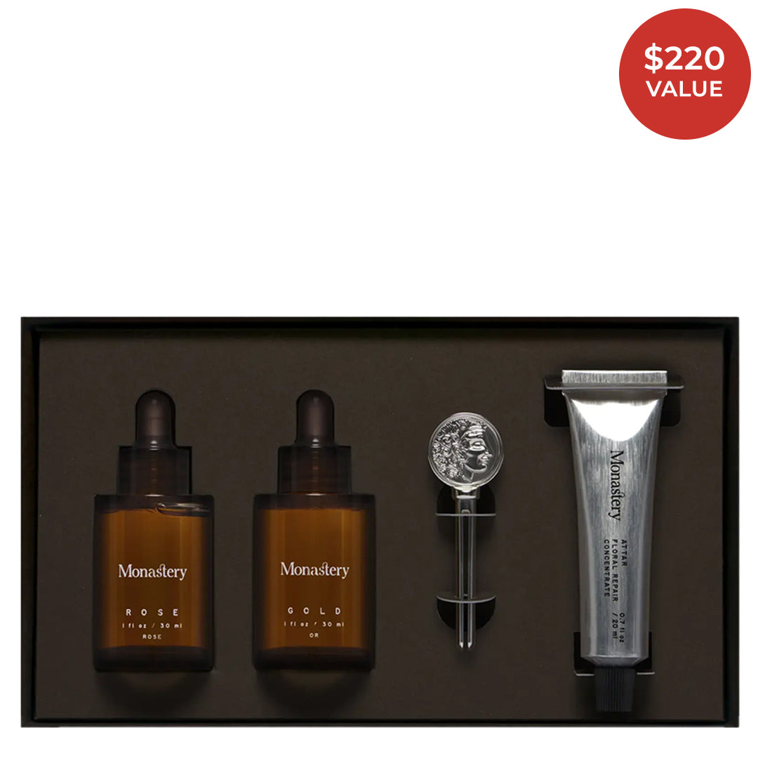 Monastery | Essentials Kit | Product Image with Red Sticker - skincare set with Rose and Gold oils, Attar Floral Repair Concentrate, and Monastery coin logo key in a black presentation box