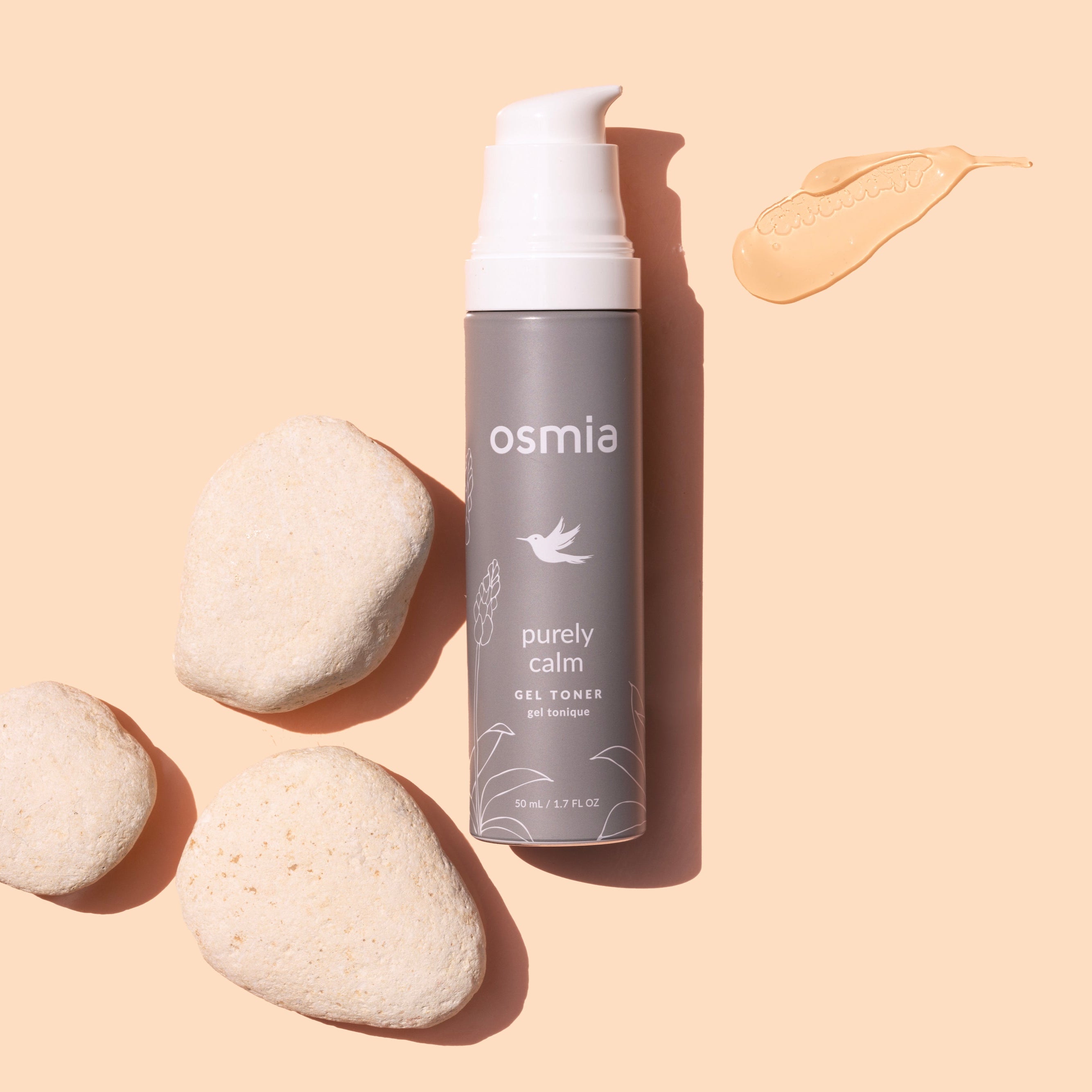 Osmia Purely Calm Gel Serum Toner bottle with pebbles on a beige background