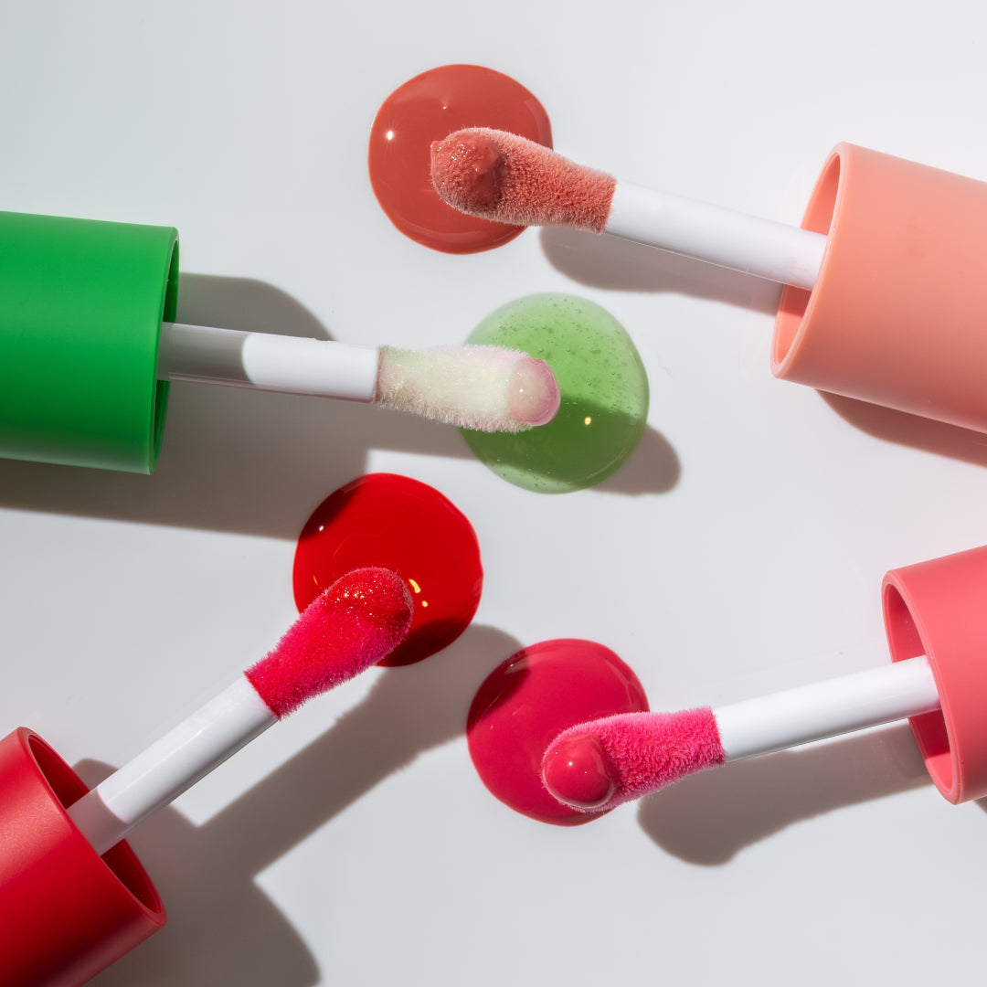 RMS Beauty | Chameleon Lip Oil | Product Image with Swatches - lip oil applicators on a white background