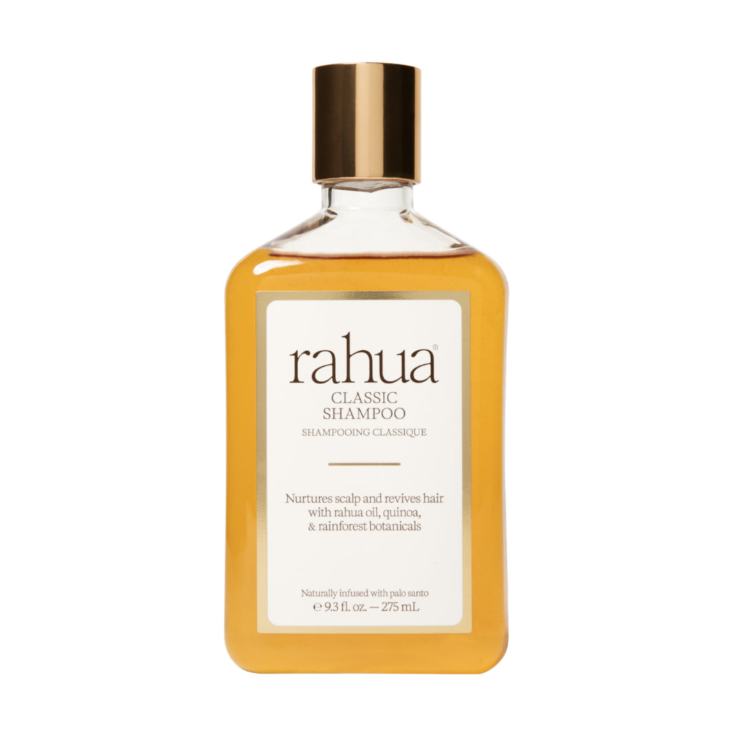 Rahua | Classic Shampoo | Product Image - bottle filled with golden shampoo and topped with a metallic gold cap, displayed against a white background