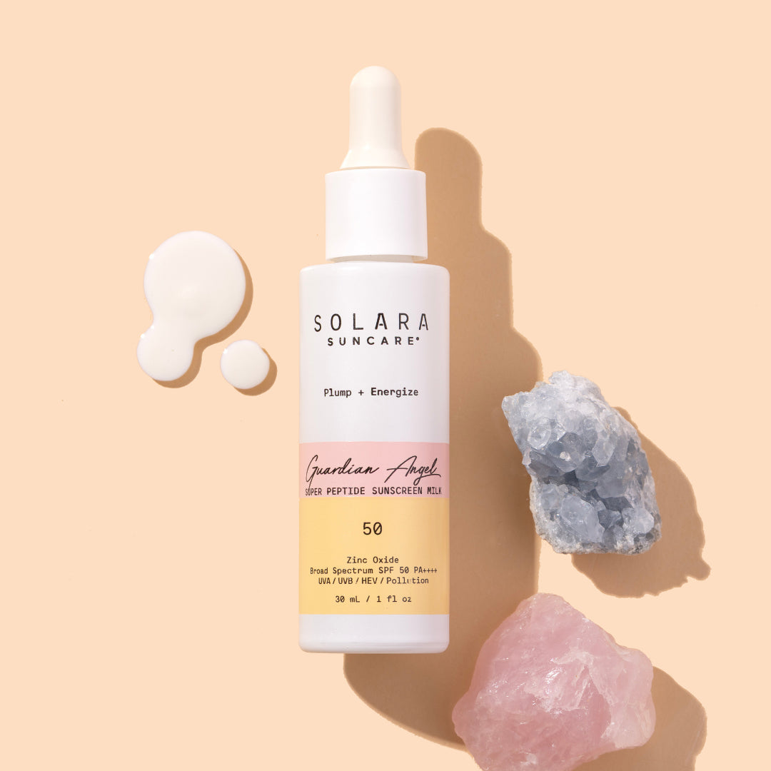 Solara Suncare | Guardian Angel Super Peptide Sunscreen Milk, SPF5O | Product Image with Swatch - bottle with yellow and pink label on a beige background.