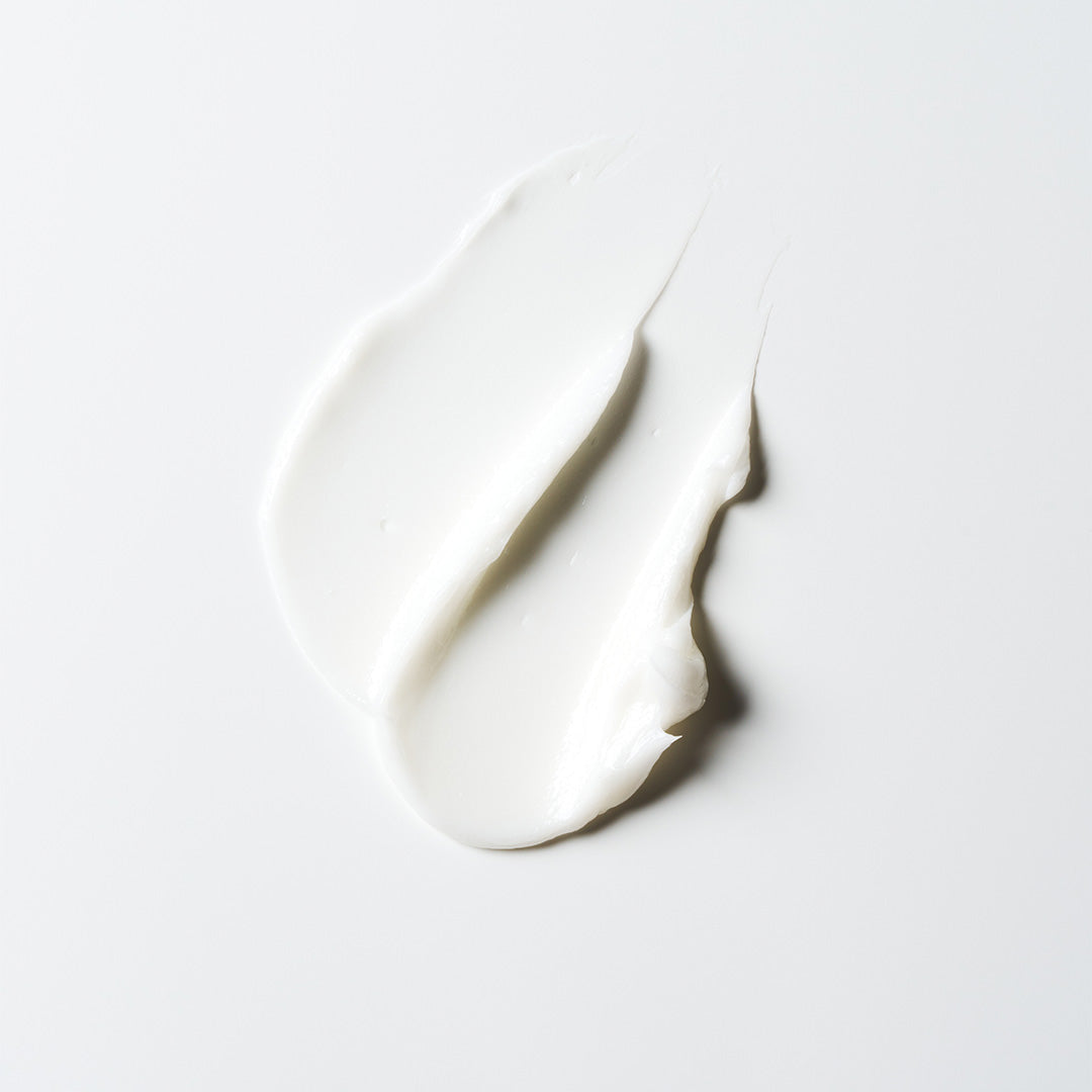 The Root Project | Instant Pleasure Silky Hair Moisturizer | Swatch Image - creamy white hair moisturizer texture swatched on a white background
