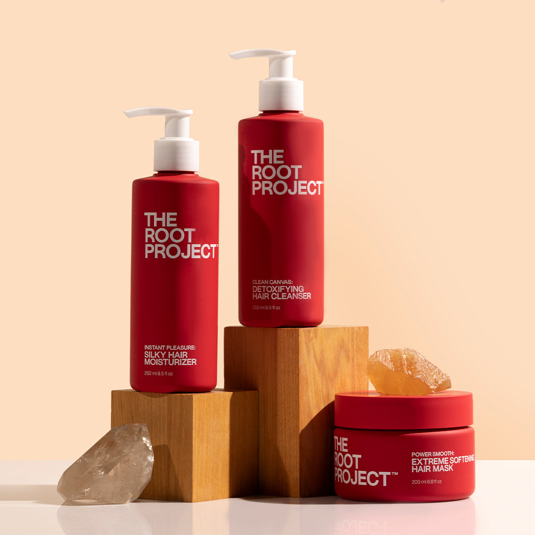 True Botanicals | Instant Pleasure, Clean Canvas & Power Smooth | Styled Image_Oct26_A - three red haircare products displayed on wooden blocks with crystal accents
