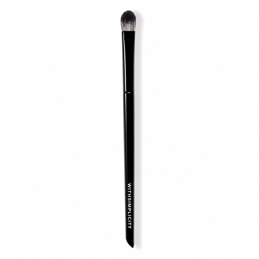 withSimplicity | Flat Eyeshadow Brush | Product Image - flat eyeshadow brush with rounded black bristles and a slim black handle on a white background