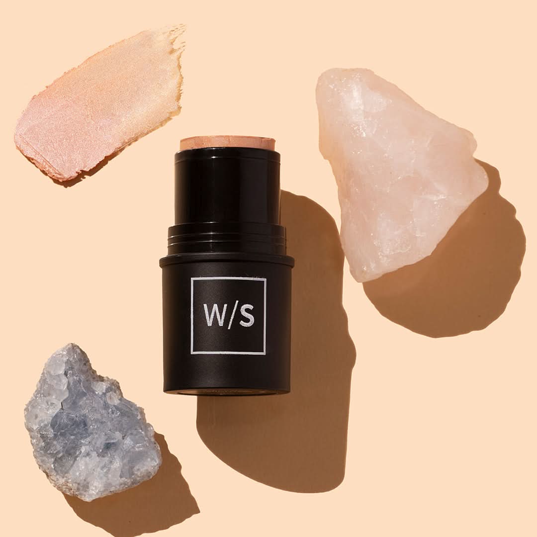 withSimplicity | Tri-Stick | Styled image with swatch, black tube on peach background