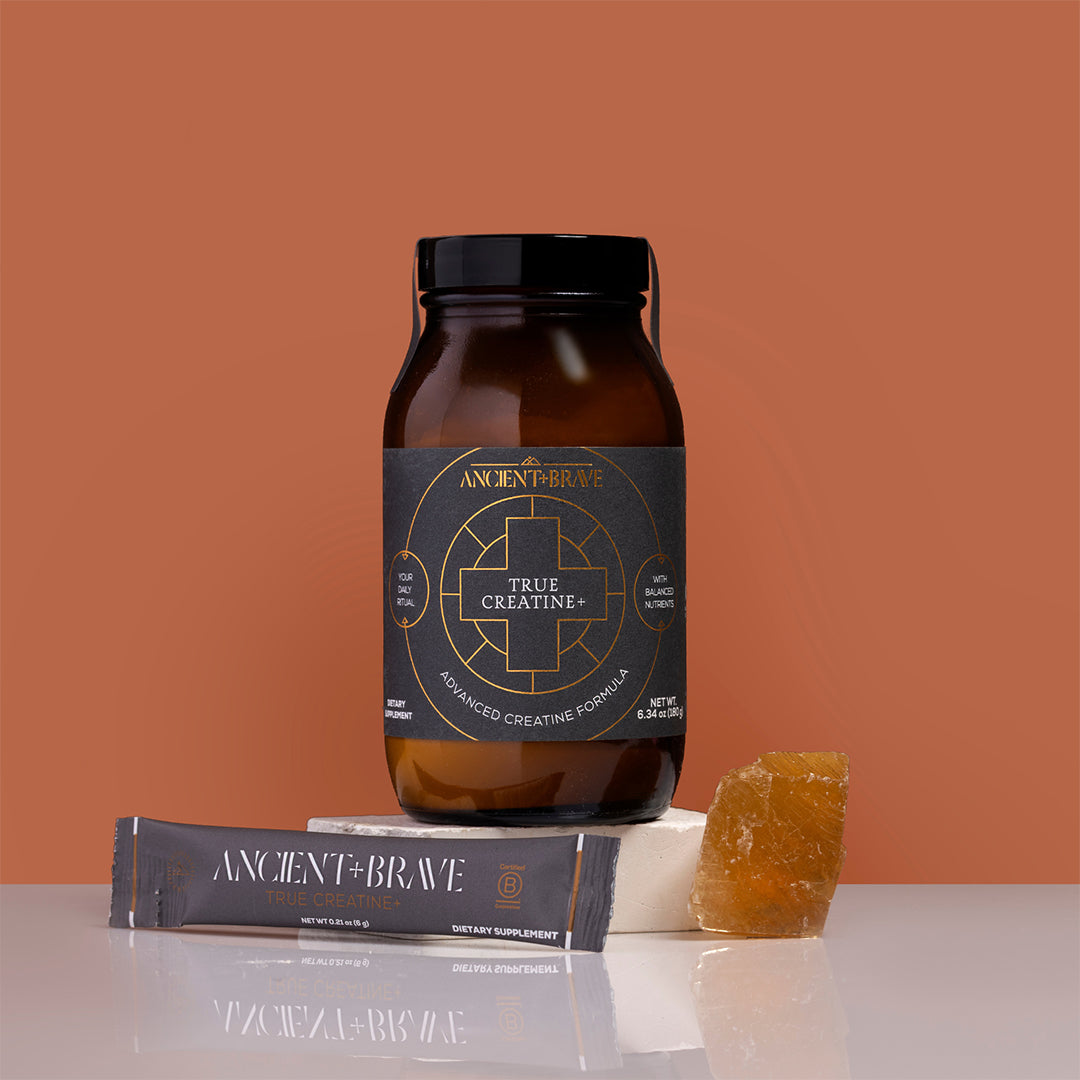 Ancient + Brave | True Creatine+ | Product Image - jar with single-serve stick and crystal on a warm brown background
