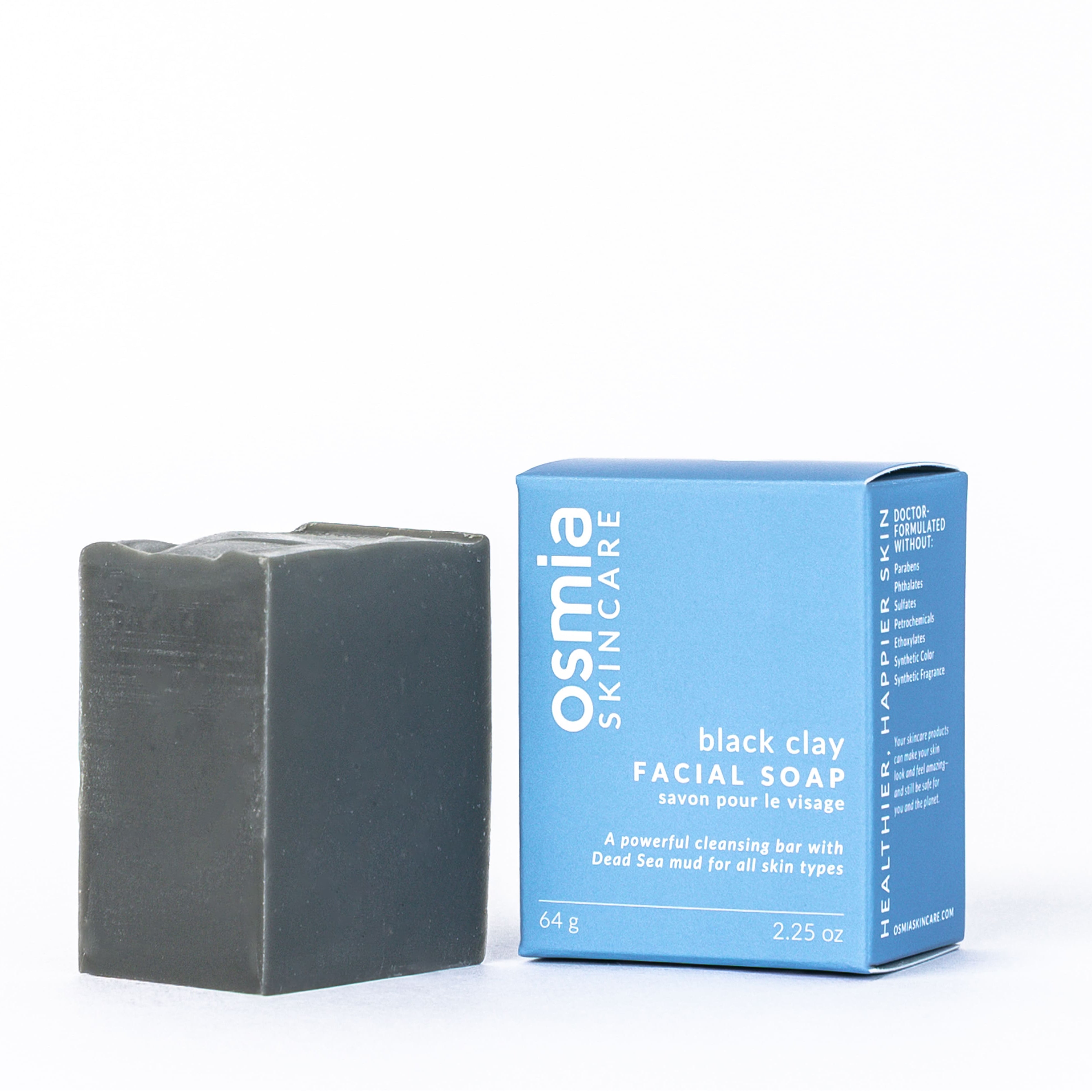 Black clay facial soap and its packaging on a white background