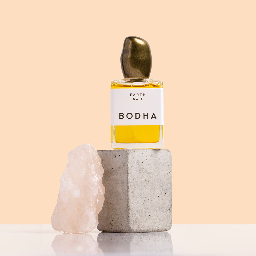 BODHA | Perfume Oil | Styled Image_Oct26 - Earth No. 1 perfume oil on a stone block beside a crystal
