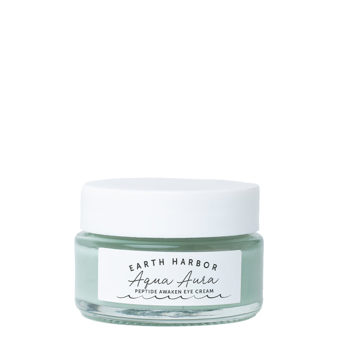 Earth Harbor | Aqua Aura Peptide Awaken Eye Cream | Product Image - pale green glass jar with a white lid on a white background