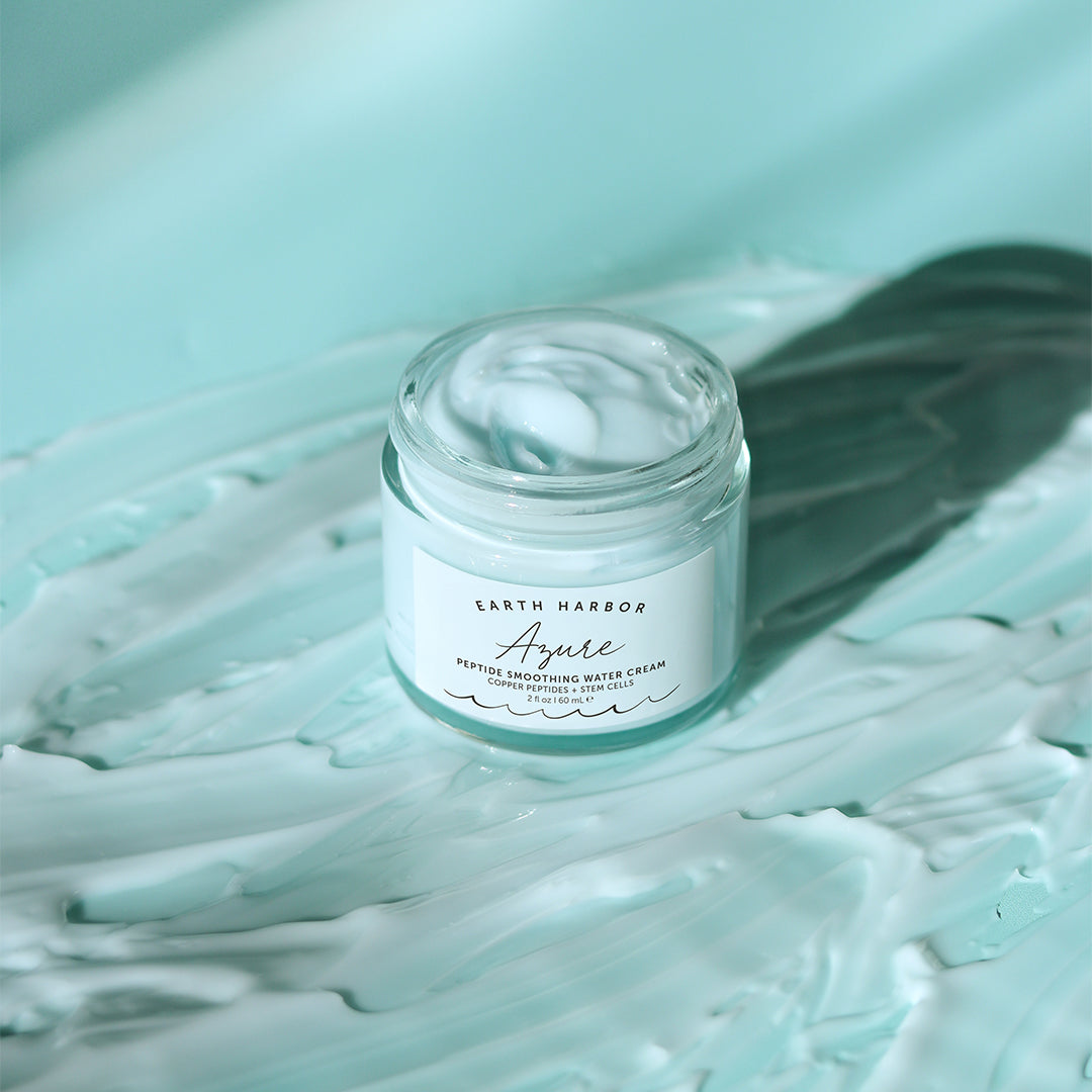 Earth Harbor | Azure Peptide Smoothing Water Cream | Texture Image - open jar of cream surrounded by light blue cream swirls