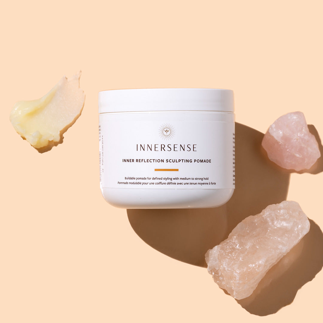 Innersense | Inner Reflection Sculpting Pomade | Styled iamge with swatch | White jar on peach background with yellow swatch
