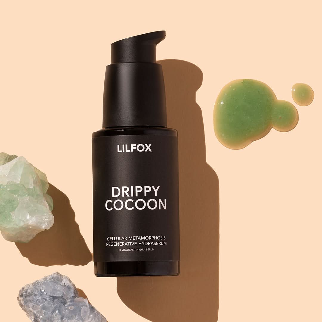 LILFOX | Drippy Cocoon | Styled product image with swatch, black bottle on peach background with green product swatch