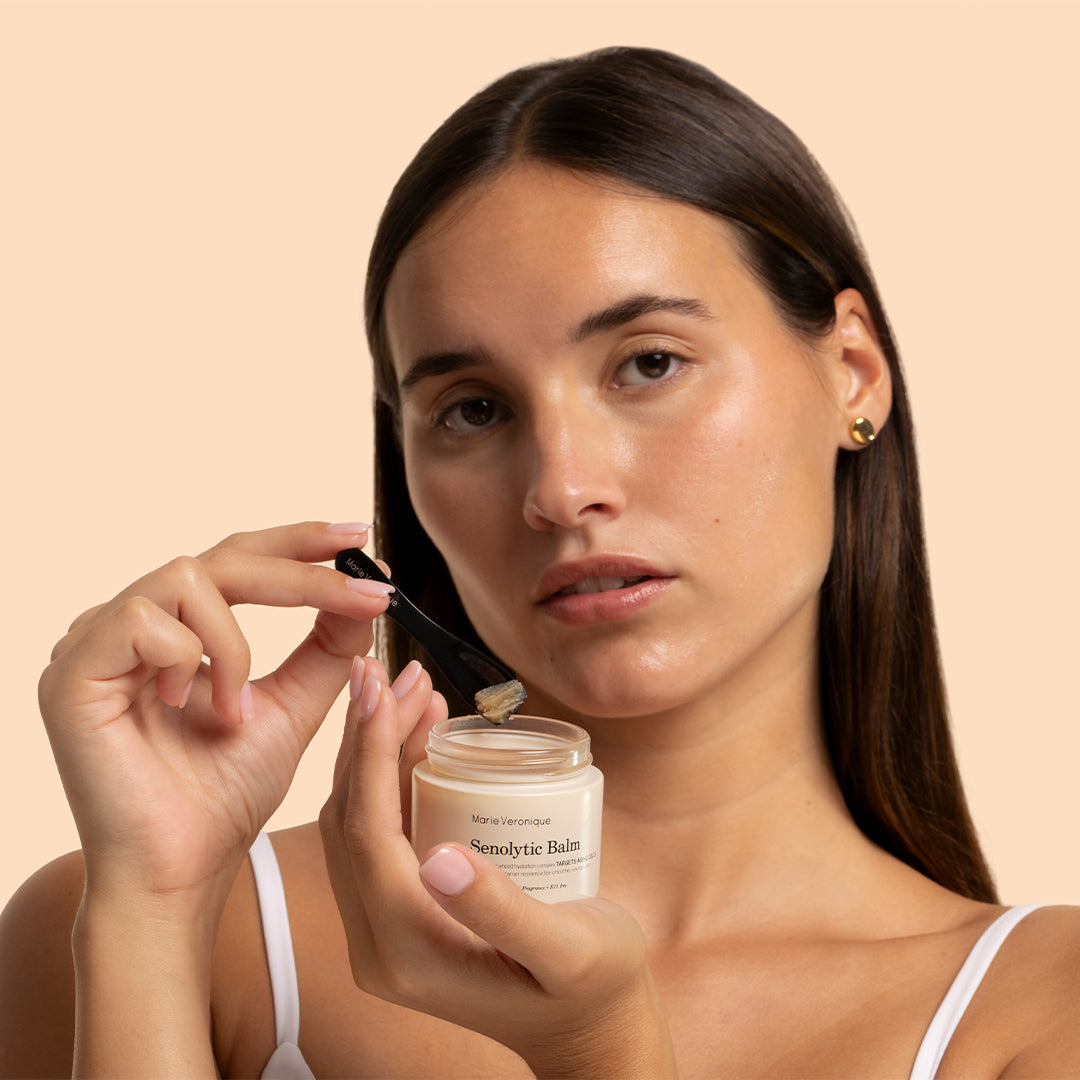Marie Veronique | Senolytic Balm | Model Image_Oct26 - Model holding balm with an applicator