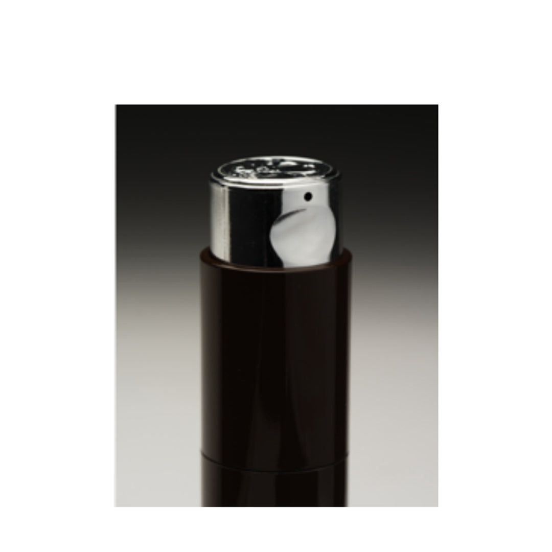 Monastery | Flora Botanical Cream Serum | Pump Detail Image - close-up of a dark brown cylindrical bottle with an exposed silver pump dispenser against a black-to-gray gradient background