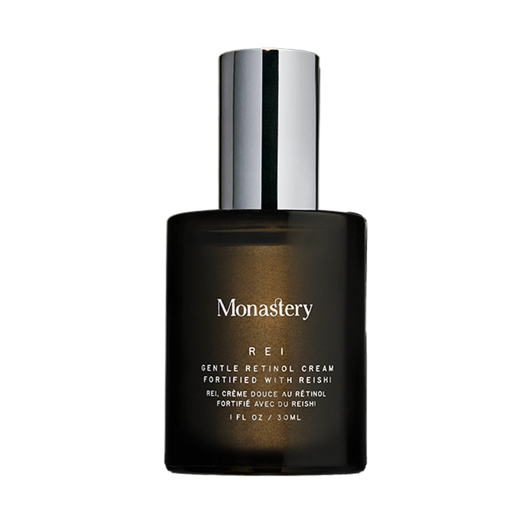 Monastery | Rei Gentle Retinol Cream | Product Image - dark amber frosted glass bottle with a silver pump cap on a white  background.