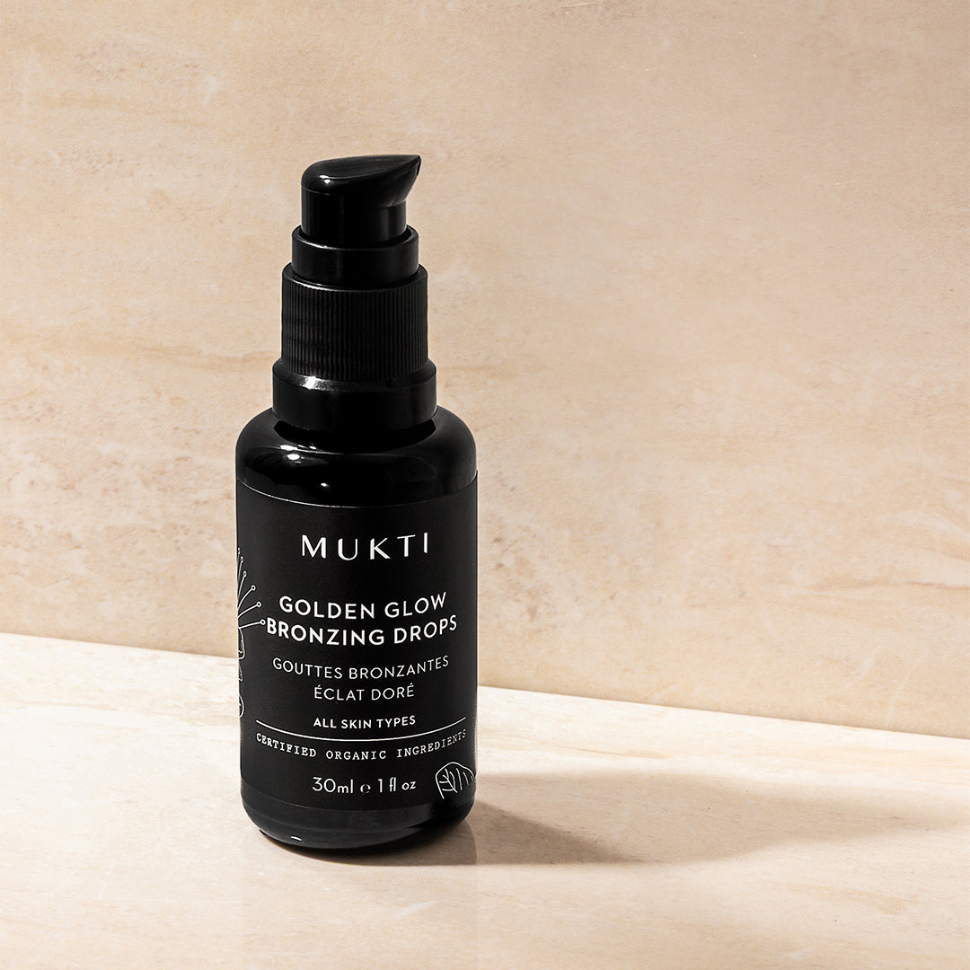 Mukti | Golden Glow Bronzing Drops | Styled Image - Golden Glow Bronzing Drops on a neutral background