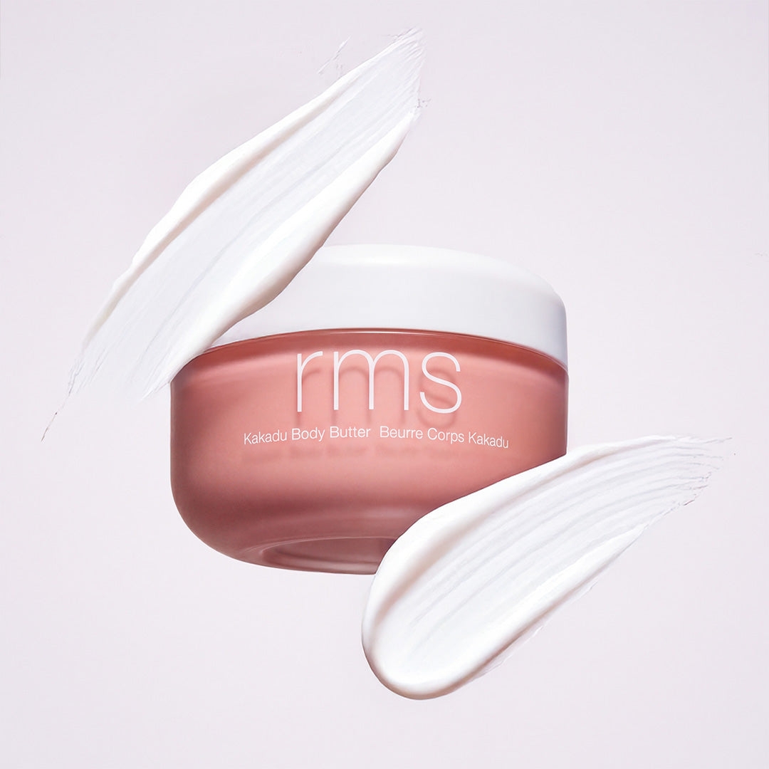 RMS Beauty | Kakadu Body Butter | Product with Swatch Image - jar with two creamy swatches on a soft light background