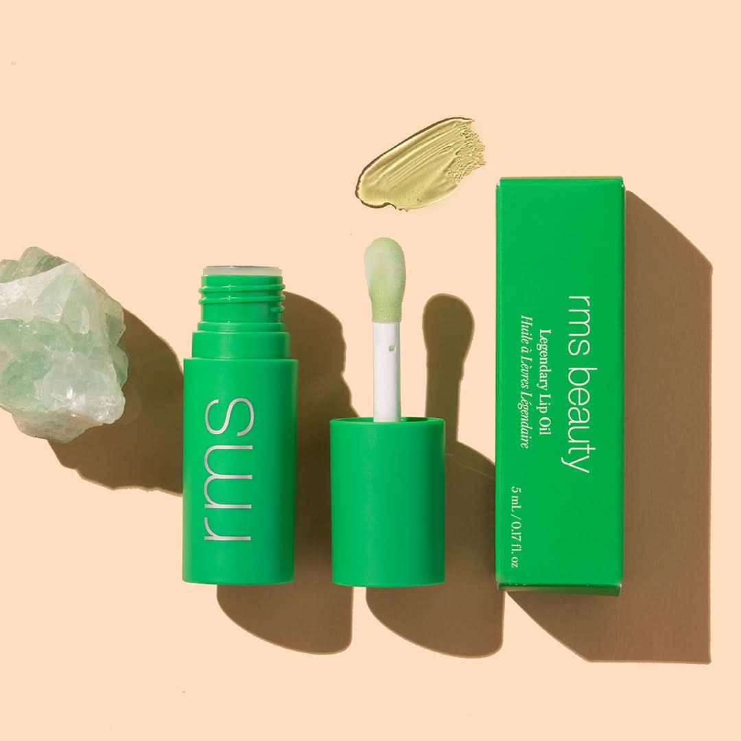 RMS Beauty | Legendary Lip Oil in shade chameleon | product flat lay on beige with green swatch