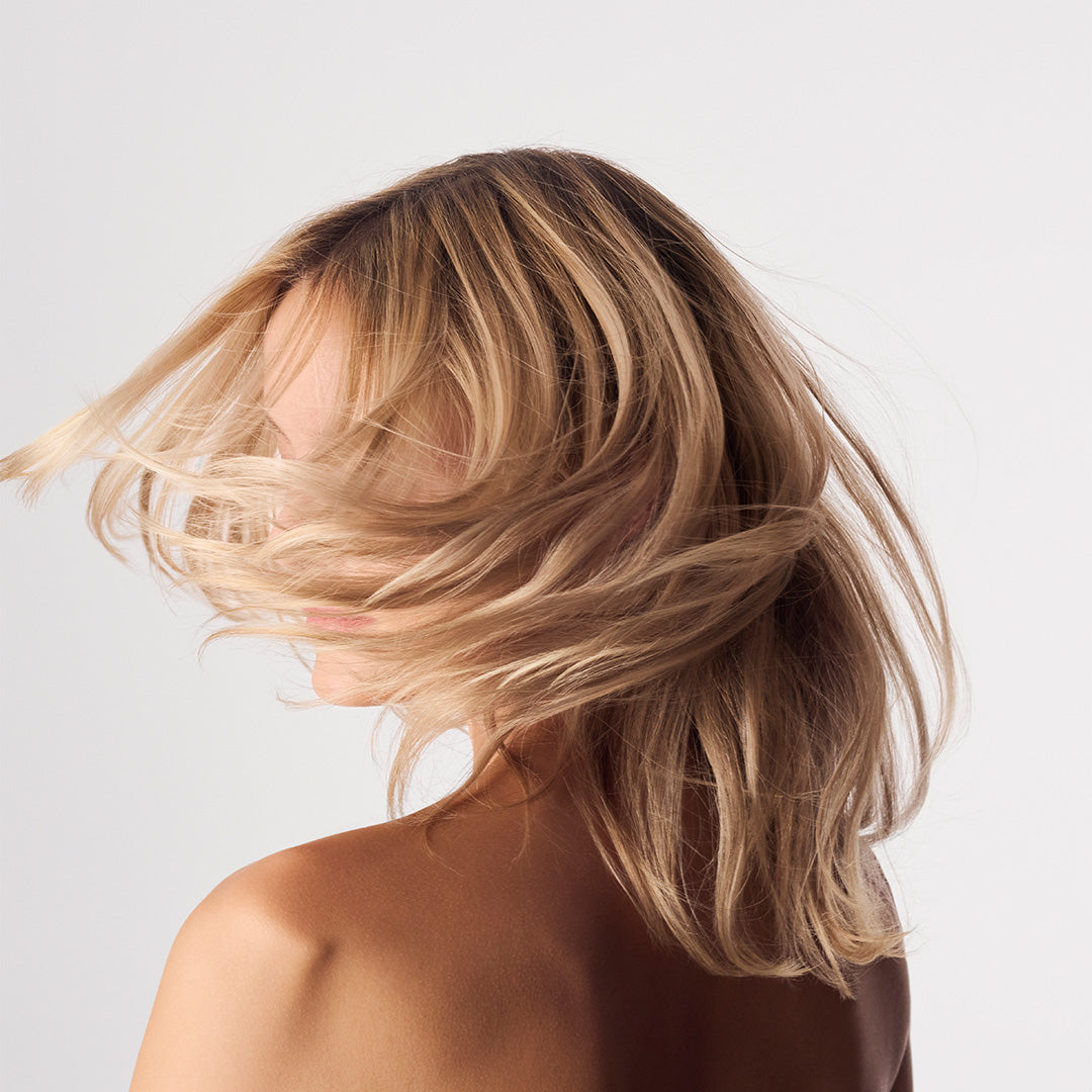 The Root Project | Clean Canvas Detoxifying Hair Cleanser | Model Image - model with blonde hair moving across her face against a white background