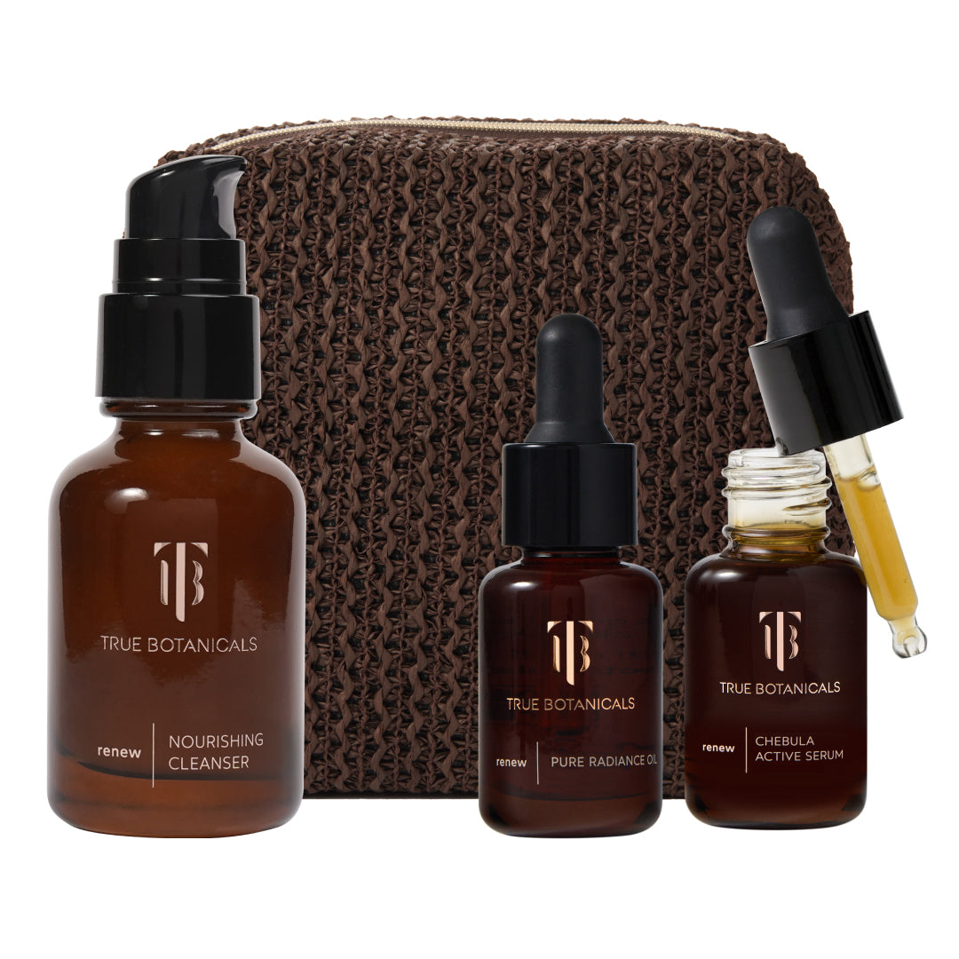 True Botanicals | A True Transformation Kit | Product Image - Renew Nourishing Cleanser, Pure Radiance Oil, and Chebula Active Serum with a brown pouch against a white background