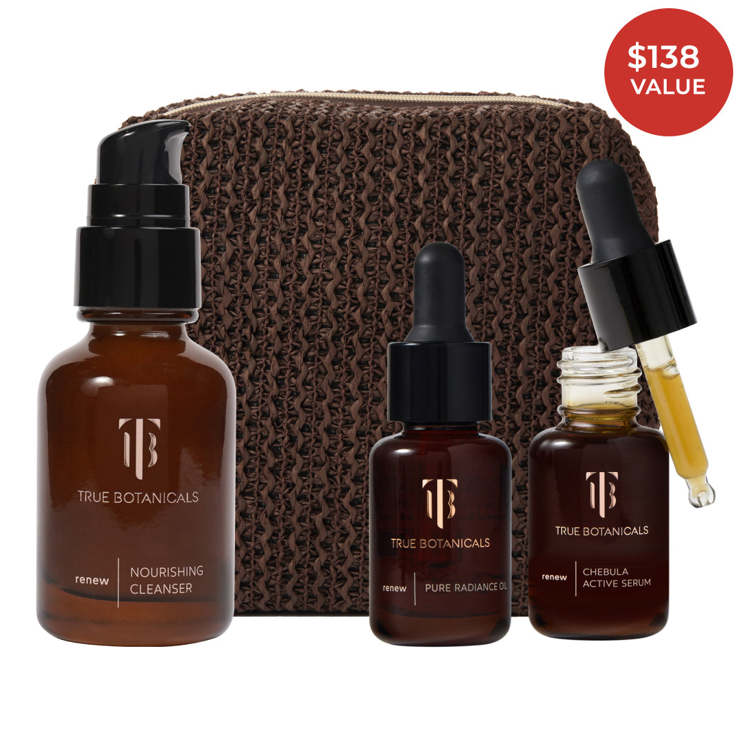 True Botanicals | A True Transformation Kit | Product Image with Red Sticker - Renew Nourishing Cleanser, Pure Radiance Oil, and Chebula Active Serum with a brown pouch against a white background