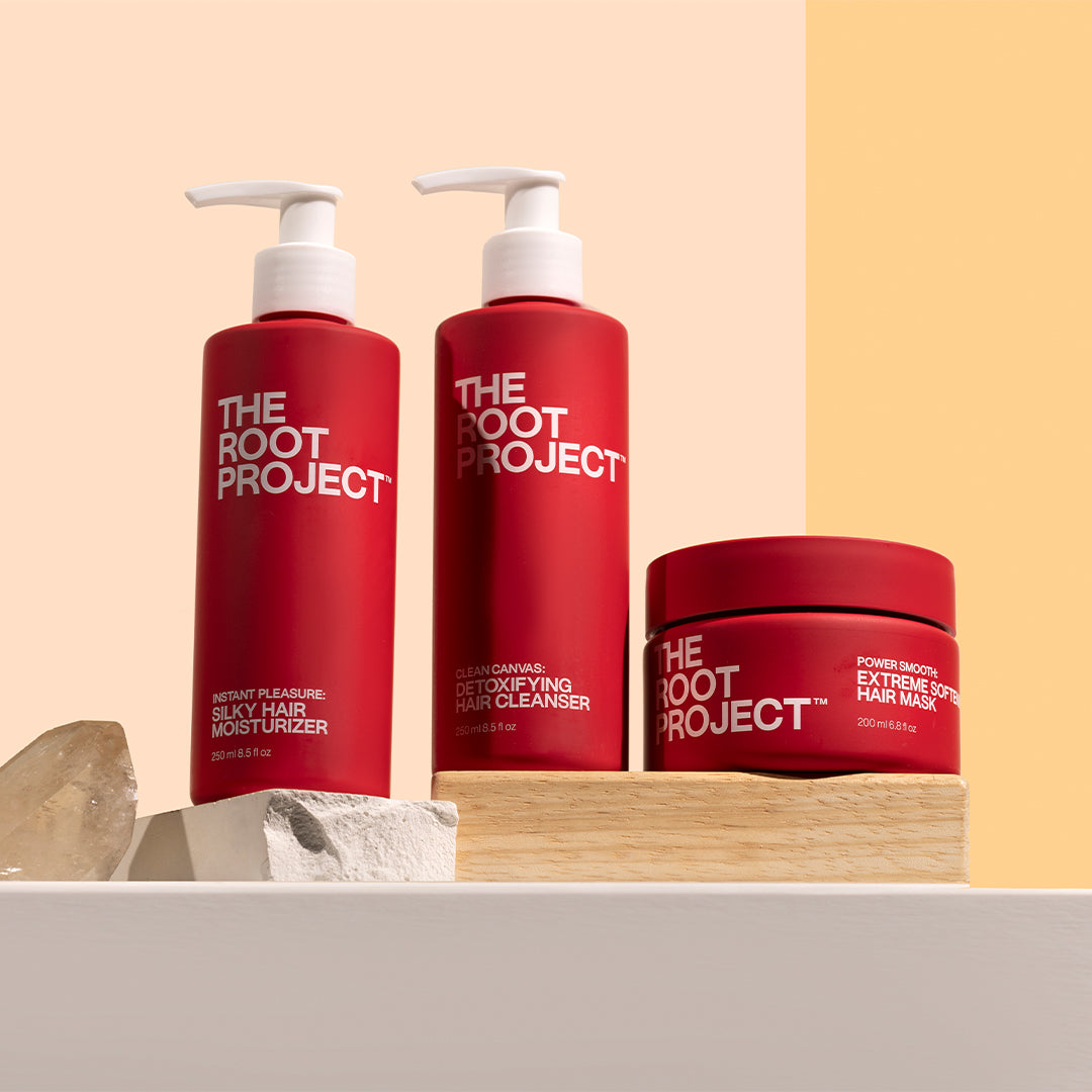 True Botanicals | Instant Pleasure, Clean Canvas & Power Smooth | Styled Image_Oct26 - three red haircare products bottle displayed on wooden blocks with crystal accents