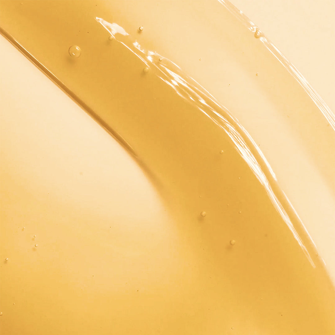 True Botanicals | Mindful Mama Belly & Body Oil | Swatch Texture Image - close-up of the golden oil texture
