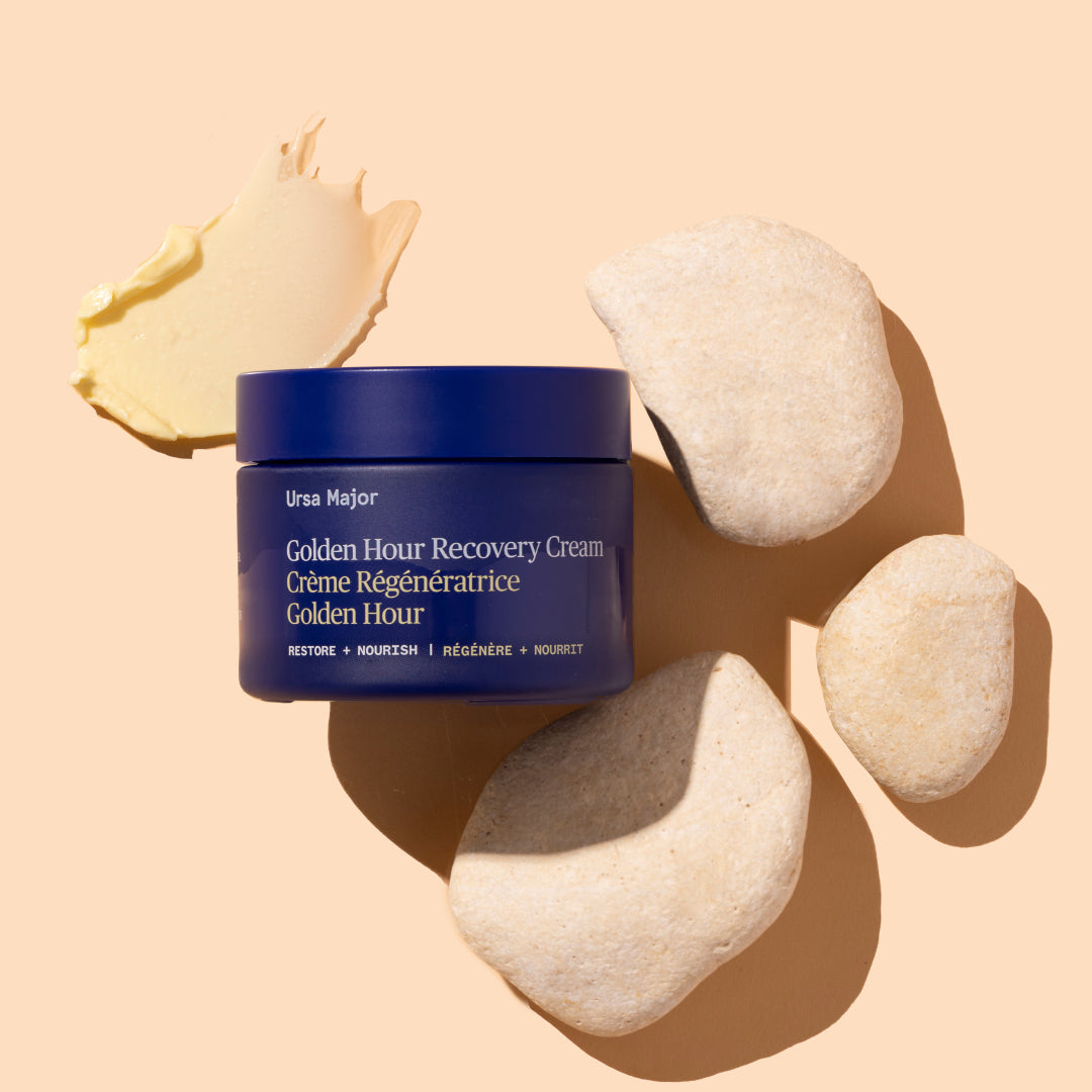 Ursa Major | Golden Hour Recovery Cream | Produtct Image with Swatch - jar with a swipe of cream and stones on a warm beige background