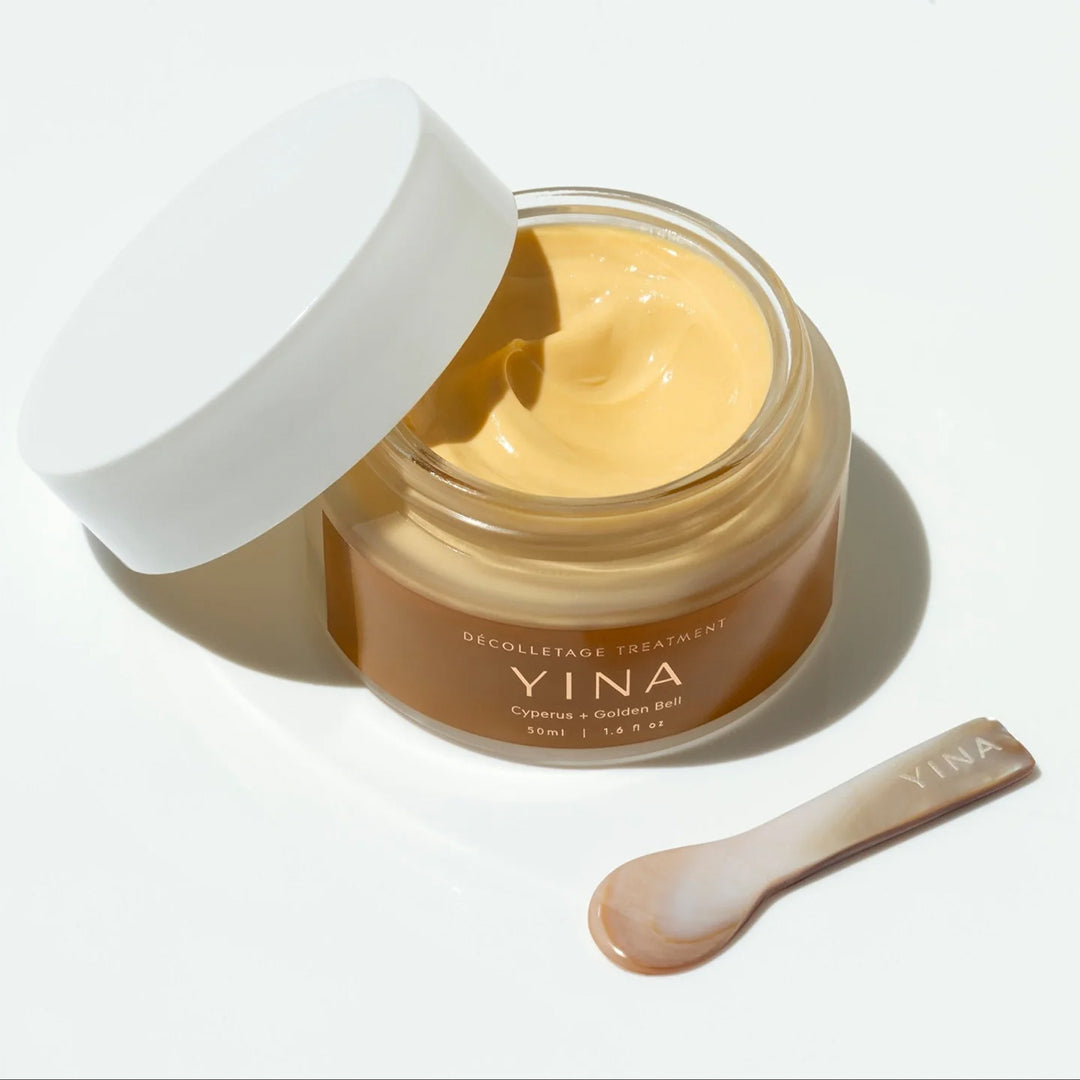 YINA | Décolletage Treatment For Neck, Chest, and Breasts | Open Jar Image - open jar with cream and branded spatula