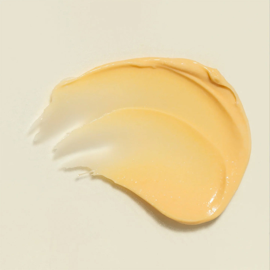 YINA | Décolletage Treatment For Neck, Chest, and Breasts | Swatch Image - rich golden cream texture swatch on a light background