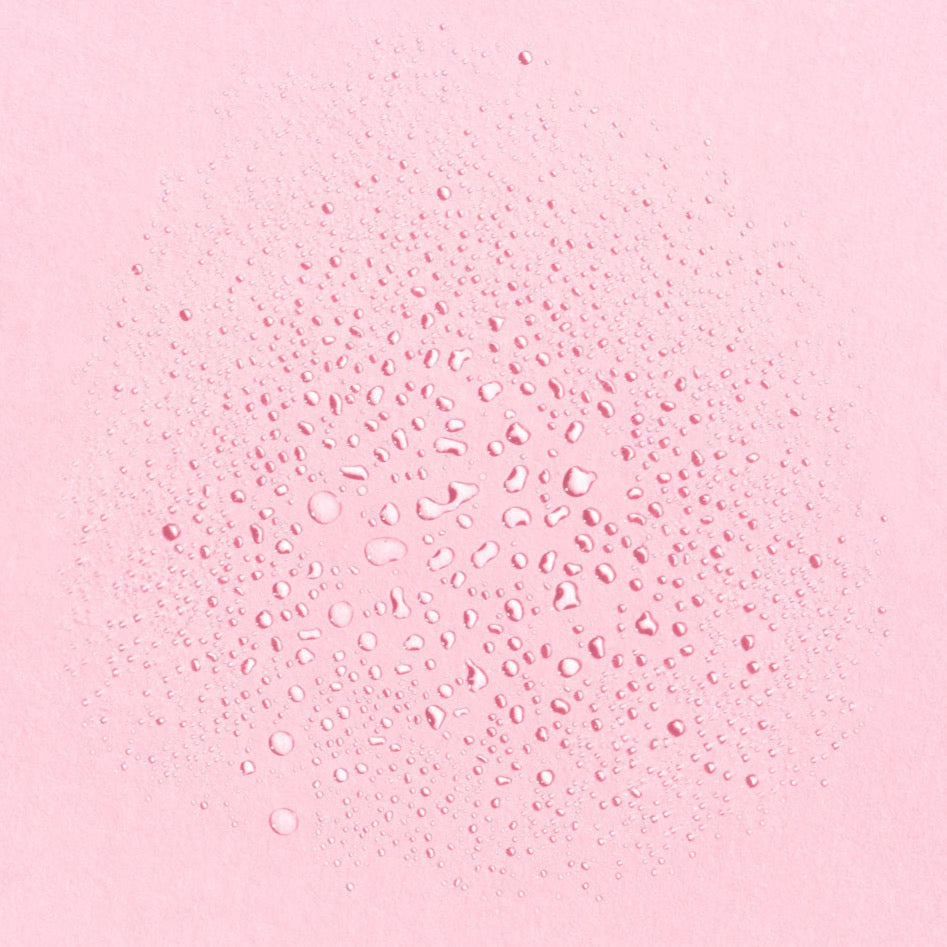 Earth Harbor | Tidal Rose Seaweed Hydration Mist | Texture Image - fine water droplets scattered across a pink background